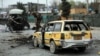 Security personnel inspect the site of a bomb attack in Kabul on March 15.