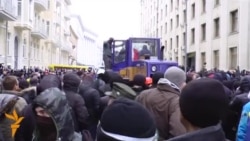 Protesters, Tractor Take On Police In Kyiv