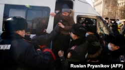 Police detain opposition supporters in Almaty during Kazakhstan's parliamentary elections on January 10.