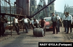 A barrel of wine is rolled over the Elisabeth Bridge in Budapest upon its structural completion in 1964.