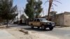 Afghan security personnel patrol a deserted street during fighting between the Taliban and Afghan security forces in Lashkar Gah on August 3.