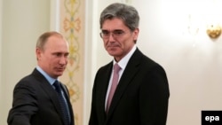 Russian President Vladimir Putin (left) meets with Siemens CEO Joe Kaeser at his Novo-Ogaryovo residence outside Moscow on March 26. Siemens is one of the German firms that will not attend the forum.