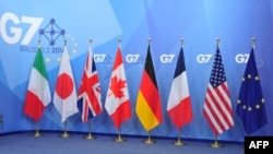 The flags of the G7 countries are seen ahead of the G7 summit at the European Council headquarters on June 4. 