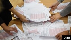 Members of a local election commission count ballots at a polling station following municipal elections in Yekaterinburg, Russia, on September 10.