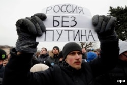 A youthful protester holds a poster reading 'Russia without Putin' as he takes part in an anticorruption rally in St. Petersburg on March 26.
