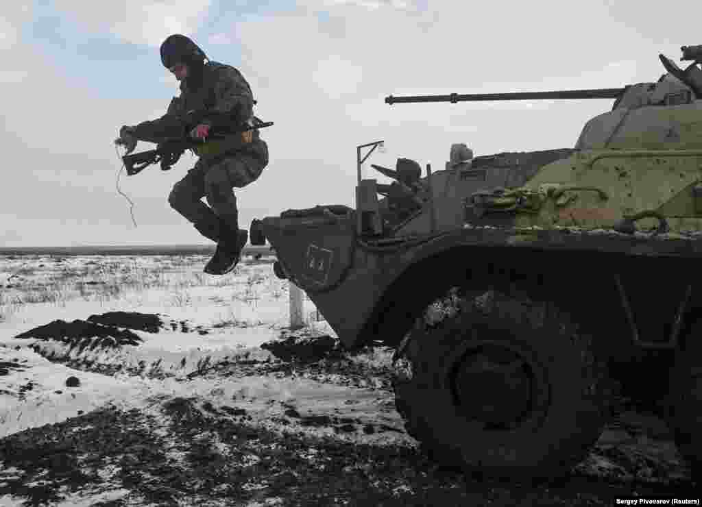 A Russian soldier leaps from an armored vehicle&nbsp;during drills at the Kuzminsky range, in Russia&#39;s southern Rostov region, on January 26. The military firing range is around 50 kilometers from the border with Ukraine.&nbsp;