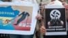 Плакати учасників протесту в Італії проти агресії Росії щодо України. Мілан, 9 червня 2015 року (ілюстраційне фото)