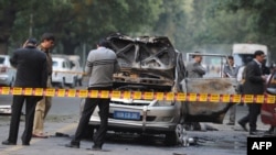 Investigators work at the site where a vehicle exploded near the Israeli Embassy in New Delhi.