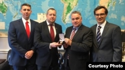 U.S. Representative Chris Smith (2nd right) receives an award from Belarusian opposition activists in May 2019.