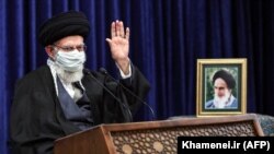 Iranian Supreme Leader Ayatollah Ali Khamenei waves as he addresses people from East Azerbaijan Province by video conference in Tehran on February 17.