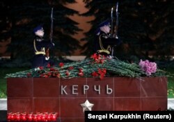Flowers and candles are seen at a memorial by the Kremlin walls in Moscow to commemorate the victims.
