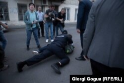A police officer tackles a man who allegedly assaulted LGBT protesters in Tbilisi on May 17.