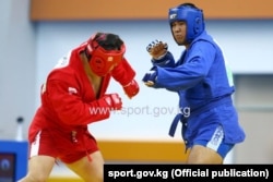 Athletes compete in the sambo combat event at the Asian Indoor Games.