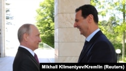 Putin welcomes Syrian President Bashar al-Assad during their meeting in Sochi earlier this year.