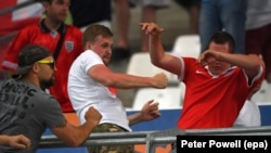 Russian soccer fans clash with an English fan (right) during the match between England and Russia at Stade Velodrome in Marseille on June 11.