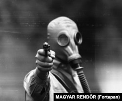 An unidentified man during a training exercise with pistols and gas masks in 1967.