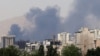 Smoke billows for the second day from the Shahran oil depot, northwest of Tehran, on June 16