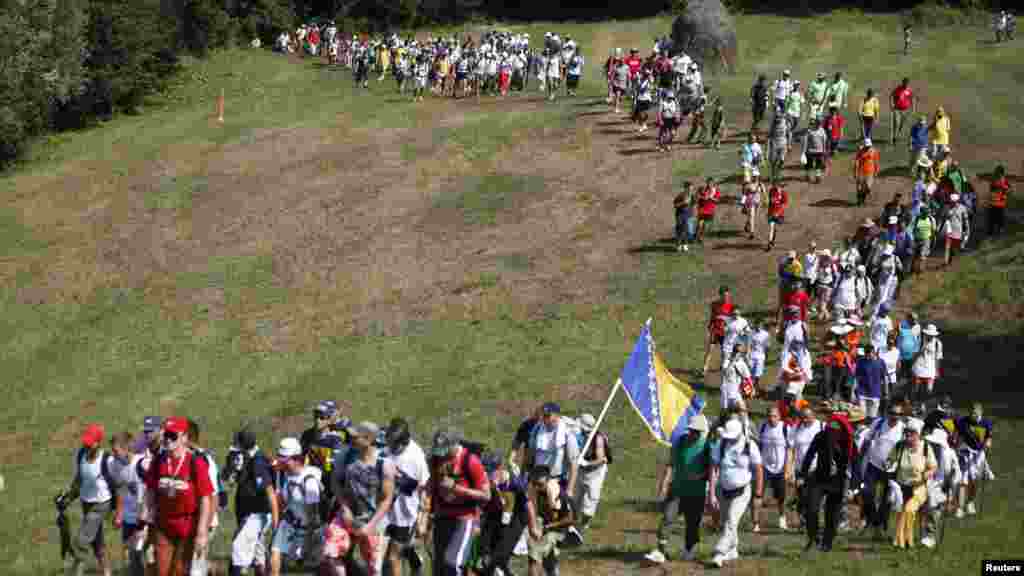 Participants in the 110-kilometer "March of Peace" walk through a forest on July 8 on their way to Srebrenica to retrace in reverse the path taken by Bosnian Muslims fleeing Serb forces in 1995.