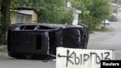 A concrete block with a sign saying "Kyrgyz Zone" stands in a street in the city of Osh on June 13.