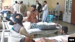 Afghan civilians injured in a coalition air strike receive treatment in Kandahar