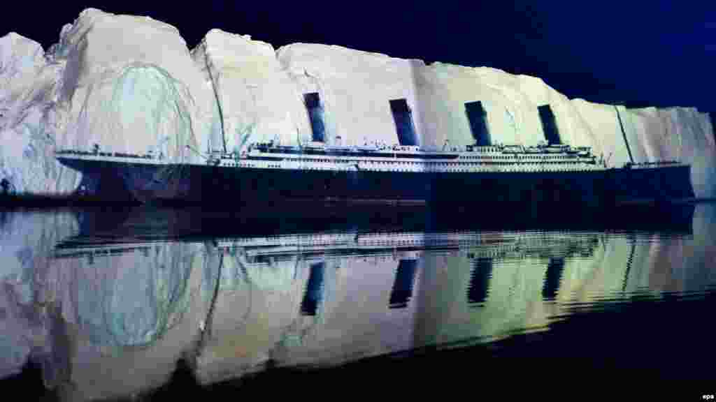 An image of the &quot;Titanic&quot; is projected on a 500-meter-long iceberg off the coast of Greenland on April 13, 2012, in a tribute to the disaster by Swiss light artist Gerry Hofstetter.