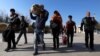 Afghan refugees cross the border into Afghanistan's Nimroz Province after they were deported by Iran. (file photo)