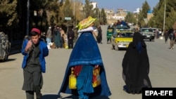تصویر آرشیف: تعدادی از زنان و مردانی که کمک های بشری را دریافت کرده اند