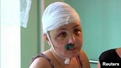 Rape victim Iryna Krashkova speaks to reporters in a hospital ward in Mykolayiv. 