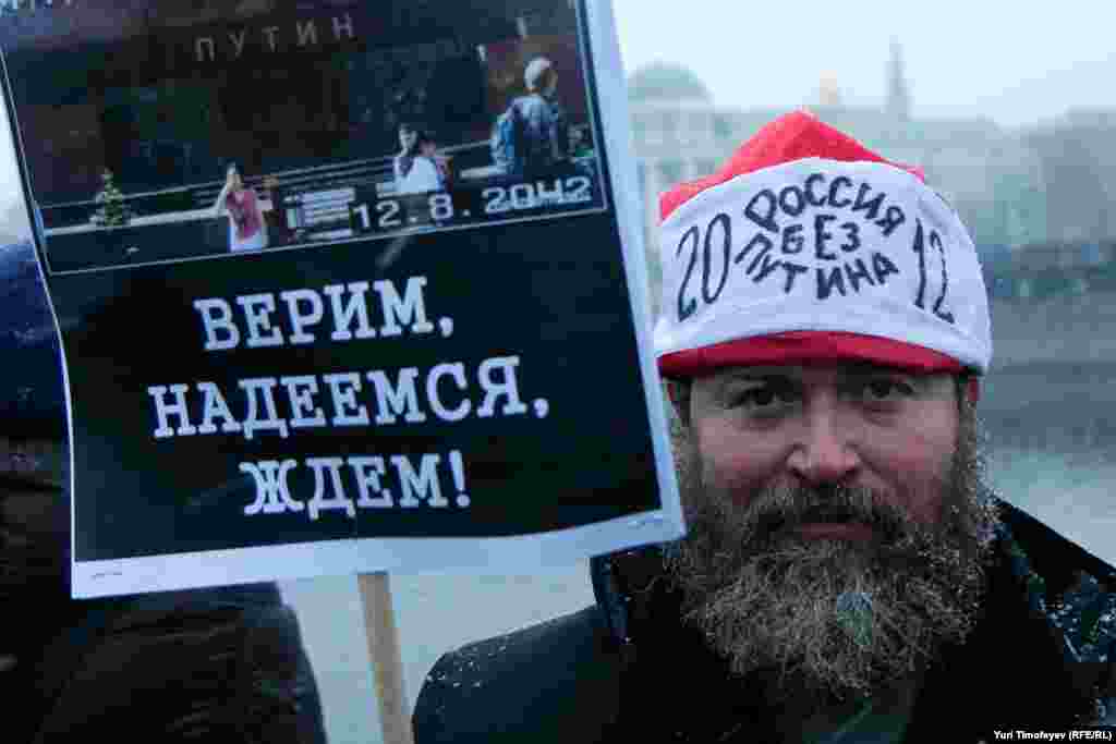 We believe, we hope, we wait" below an image of Lenin's Mausoleum with Putin's name on it.