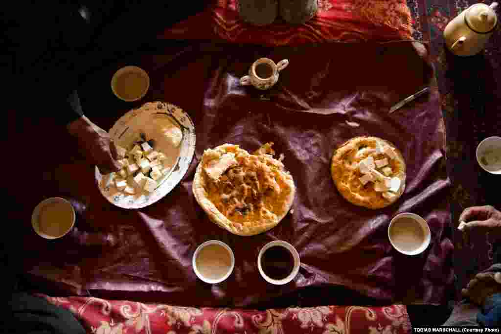A typical daytime meal for the Pamir Kyrgyz: bread, tea with milk, and rock salt -- and sometimes fresh cheese. Evening meals include meat and rice. Malnutrition among the Pamir Kyrgyz stems from a lack of the vitamins that come from fruits and vegetables, which are rare. 