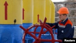 Співробітник повертає вентиль крану на газовій компресорній станції у місті Боярка, 22 квітня 2015 року.