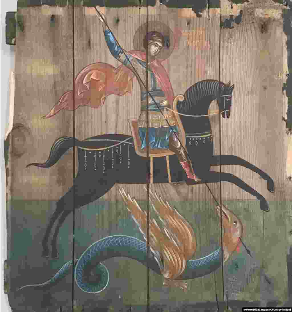 St. George slays a dragon on an ammunition-box panel from the front lines at Avdiyivka, Ukraine. Klymenko says: “Most people think of this war as of something very far away. It was important for me to show people that the war is real, that this ammunition box is real, and it stored real weapons that killed real people.” He told Reuters: “I don’t want this war to exist. And I don’t want this project to exist either.”