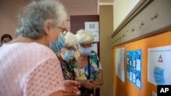 A woman checks instructions at a voting station in Bulgaria's inconclusive July election. Voters return to the polls on November 14.