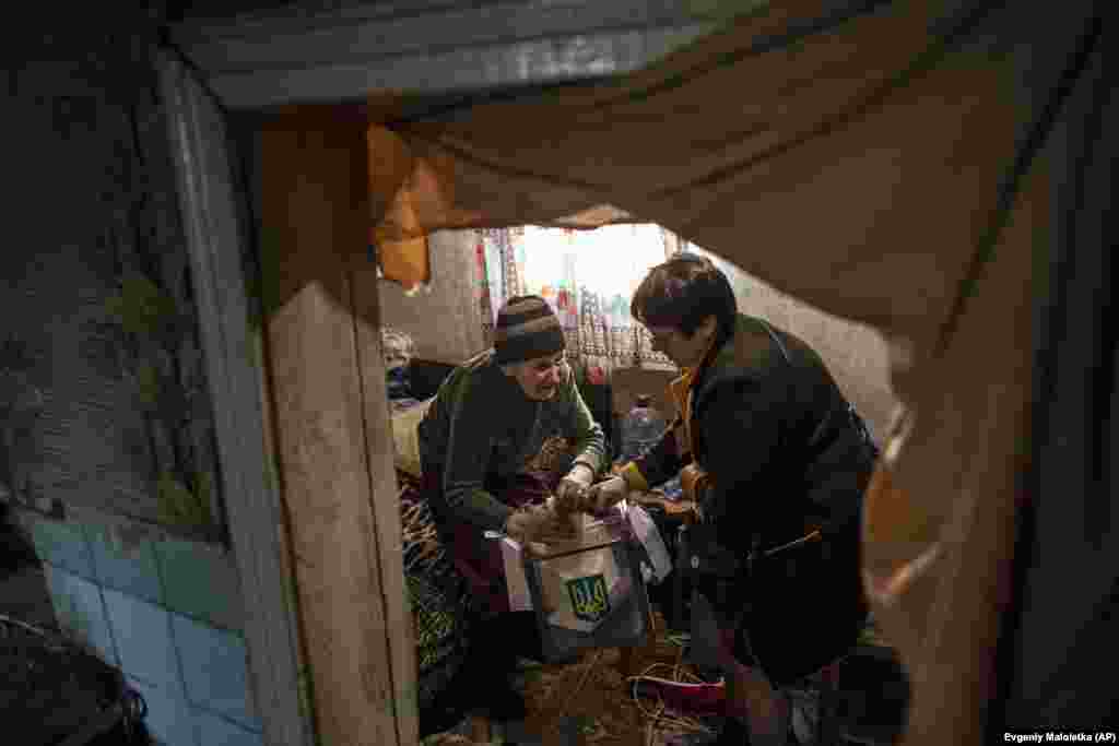 An elderly woman casts her ballot at home in Maryinka, eastern Ukraine. (AP/Evgeniy Maloletka)