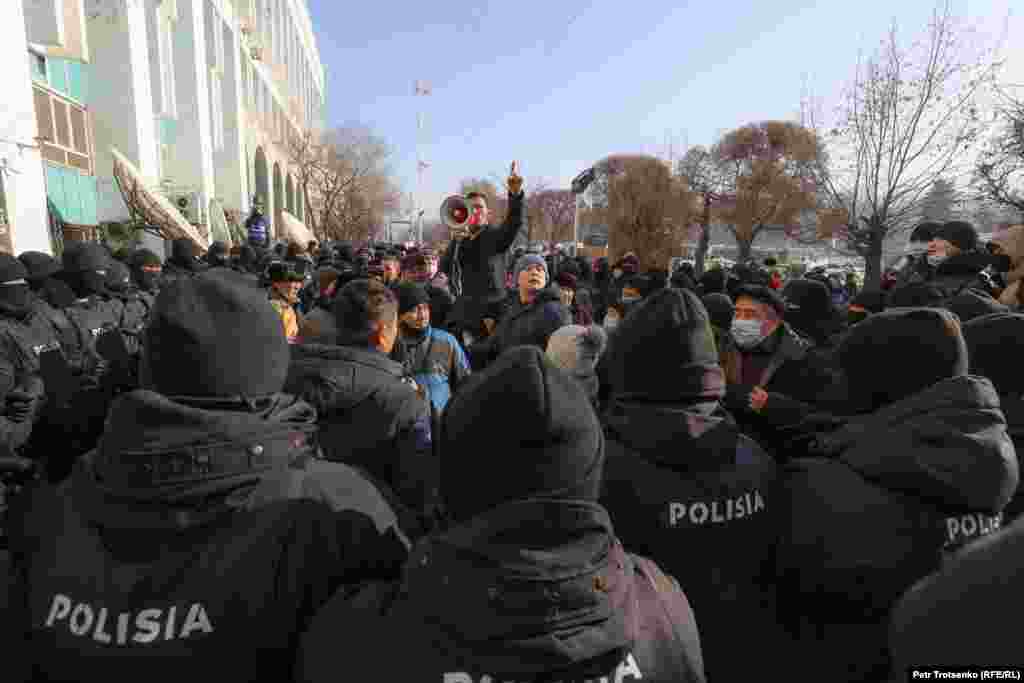 Activists are surrounded by police in Almaty.
